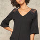 A Knit Top With Deep V Neckline And Yoke Design