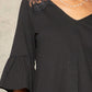 A Knit Top With Deep V Neckline And Yoke Design